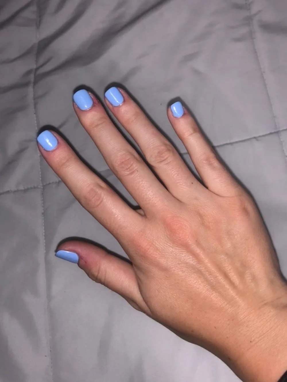A finished glossy manicure in soft blue at iLash Salon and Nails Spa